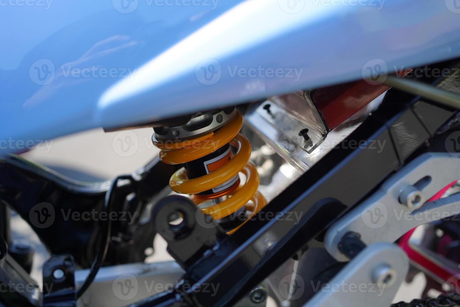 close up of monoshock spare parts from the 4-Stroke underbone motorbike category, yellow pear. photo
