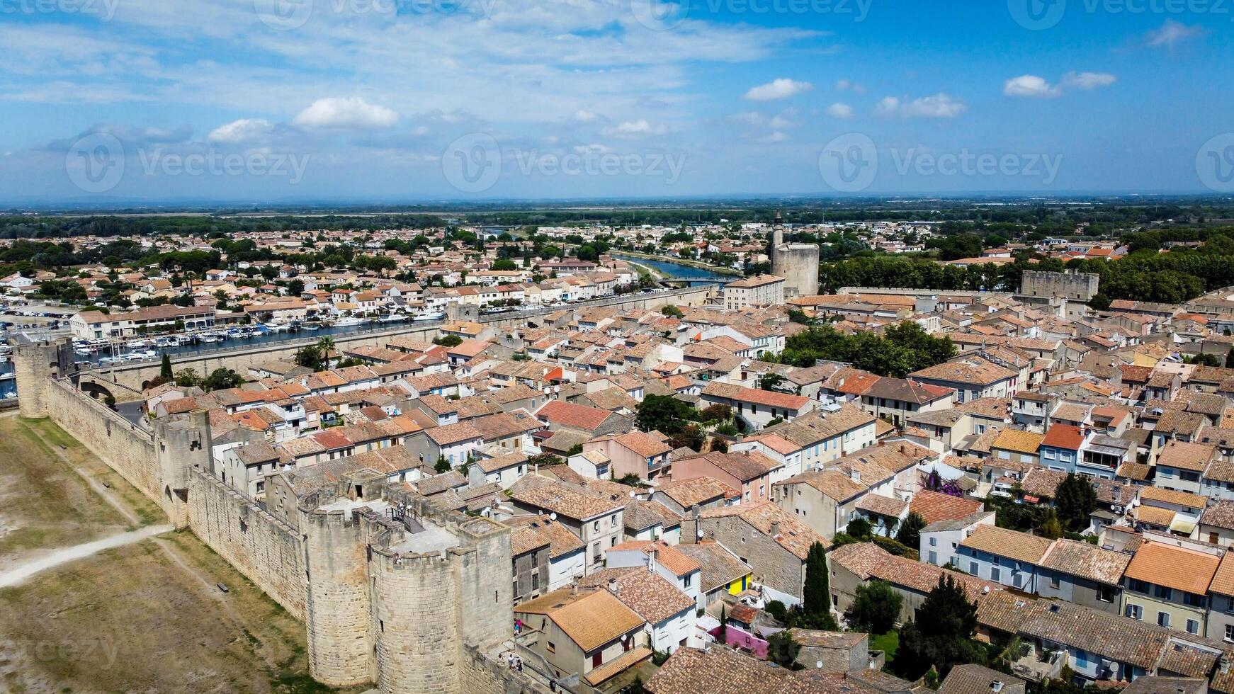 Citadel of the city of Aigues-Mortes seen from a drone. Medieval village with a rectangular plan delimited by a city wall. Tourist town is located near the salt pans and the purple sea. Provence photo