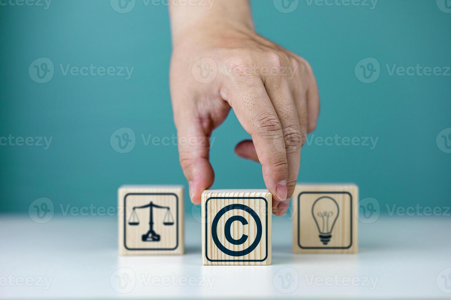 Copyright symbol or intellectual property rights of patentee on wooden cube. Business concept of author rights, designer, and trademark license photo