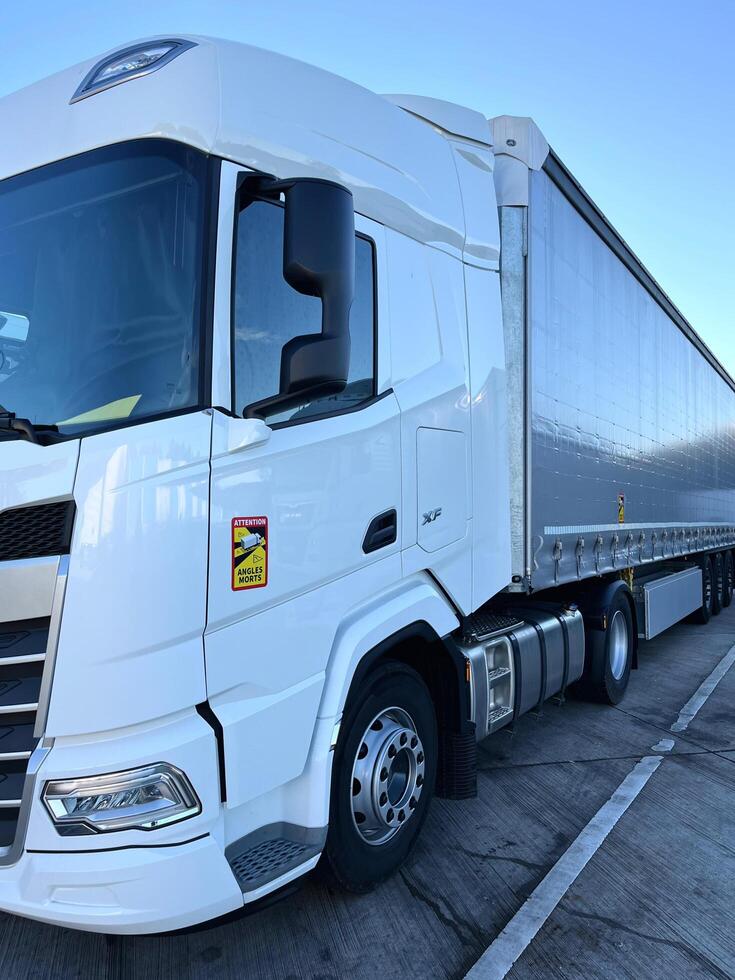 Poznan, Poland 01.03.2023 New DAF XF truck with schmitz curtain trailer photo
