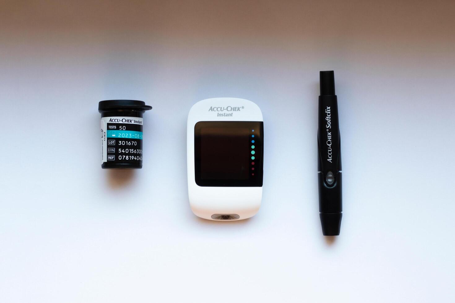Poznan, Poland - 10.20.2022 Accu-Chek Instant glucose meter with test strips and finger piercing device photo