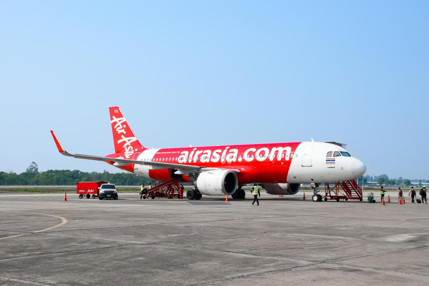SAKONNAKHON, THAILAND - APRIL 24, 2024, Thai AirAsia planes parked at tarmac preparing to take off and transport passengers for boarding from Sakon Nakhon Airport to Don Mueang International Airport. photo