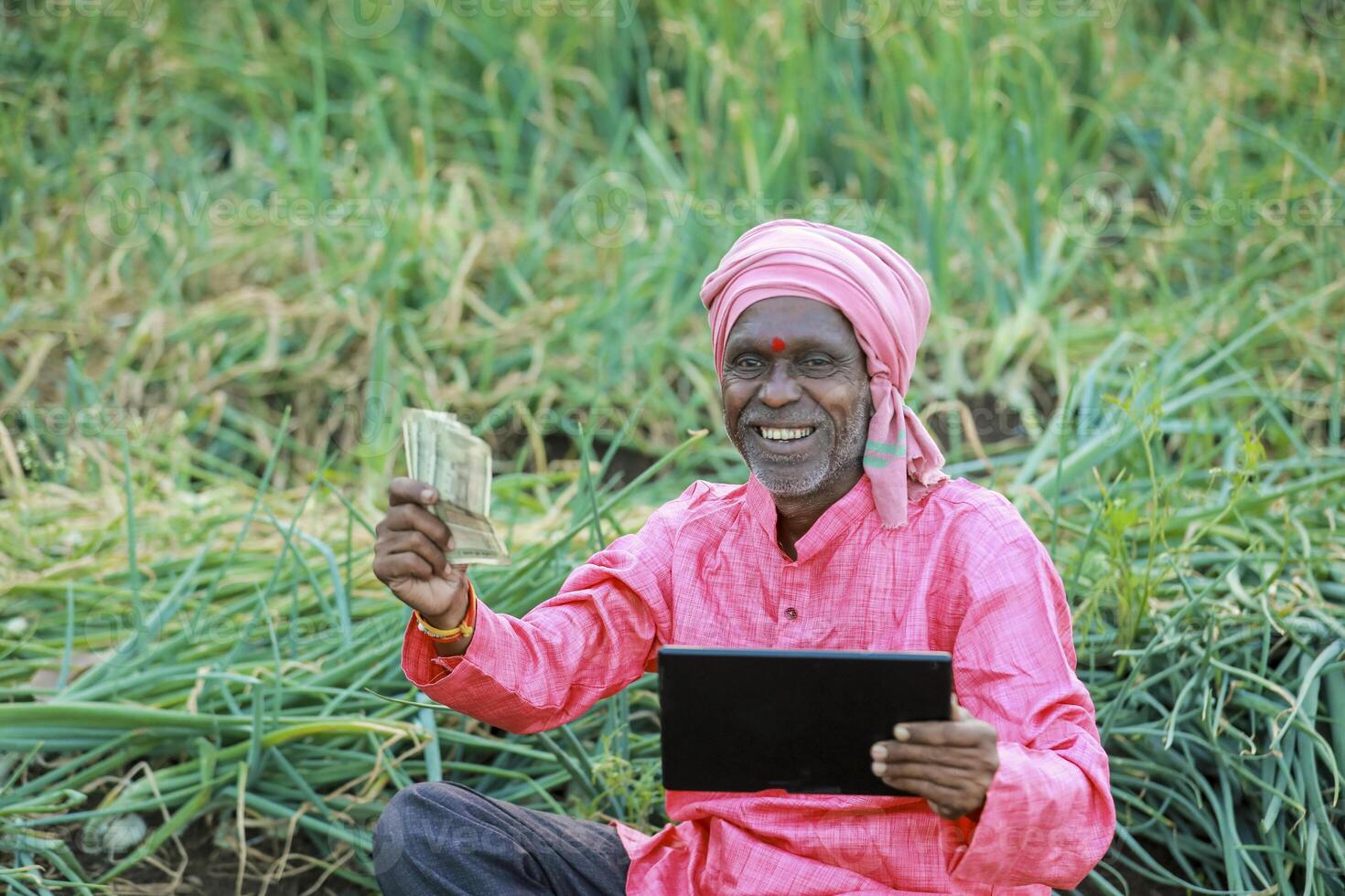 Indian farm worker holding tablet photo