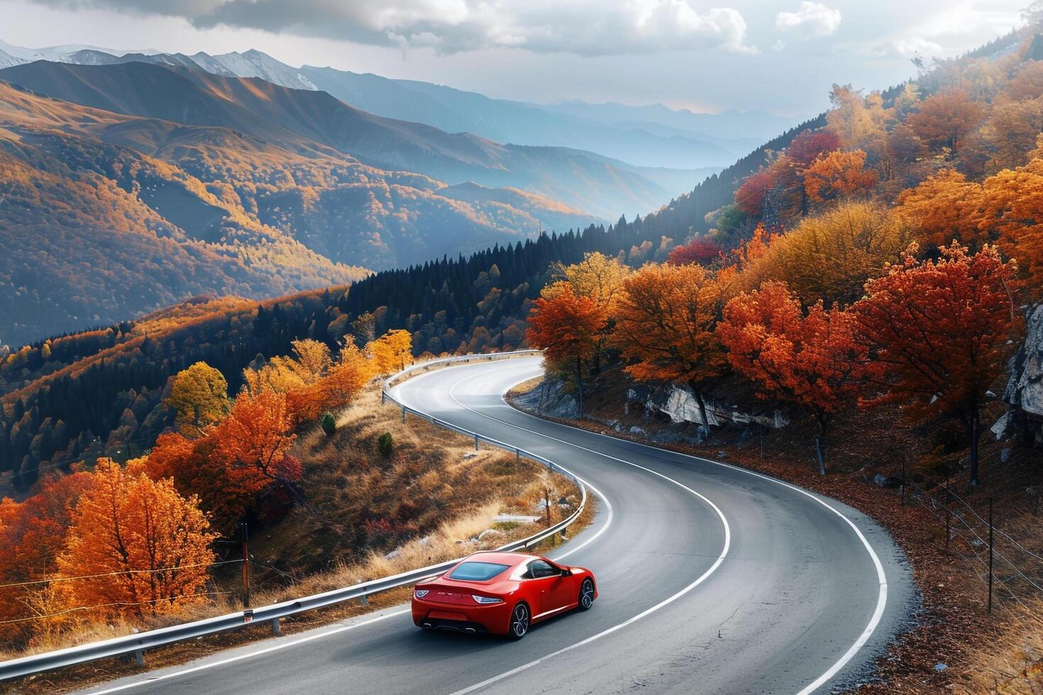 Speed Compact sports car speeding along winding mountain road with autumn foliage and distant mountain peaks photo
