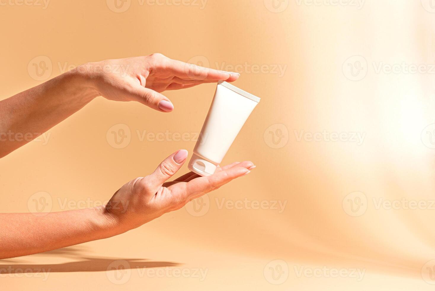 Female hands hold moisturizer cream. Beauty routine. photo