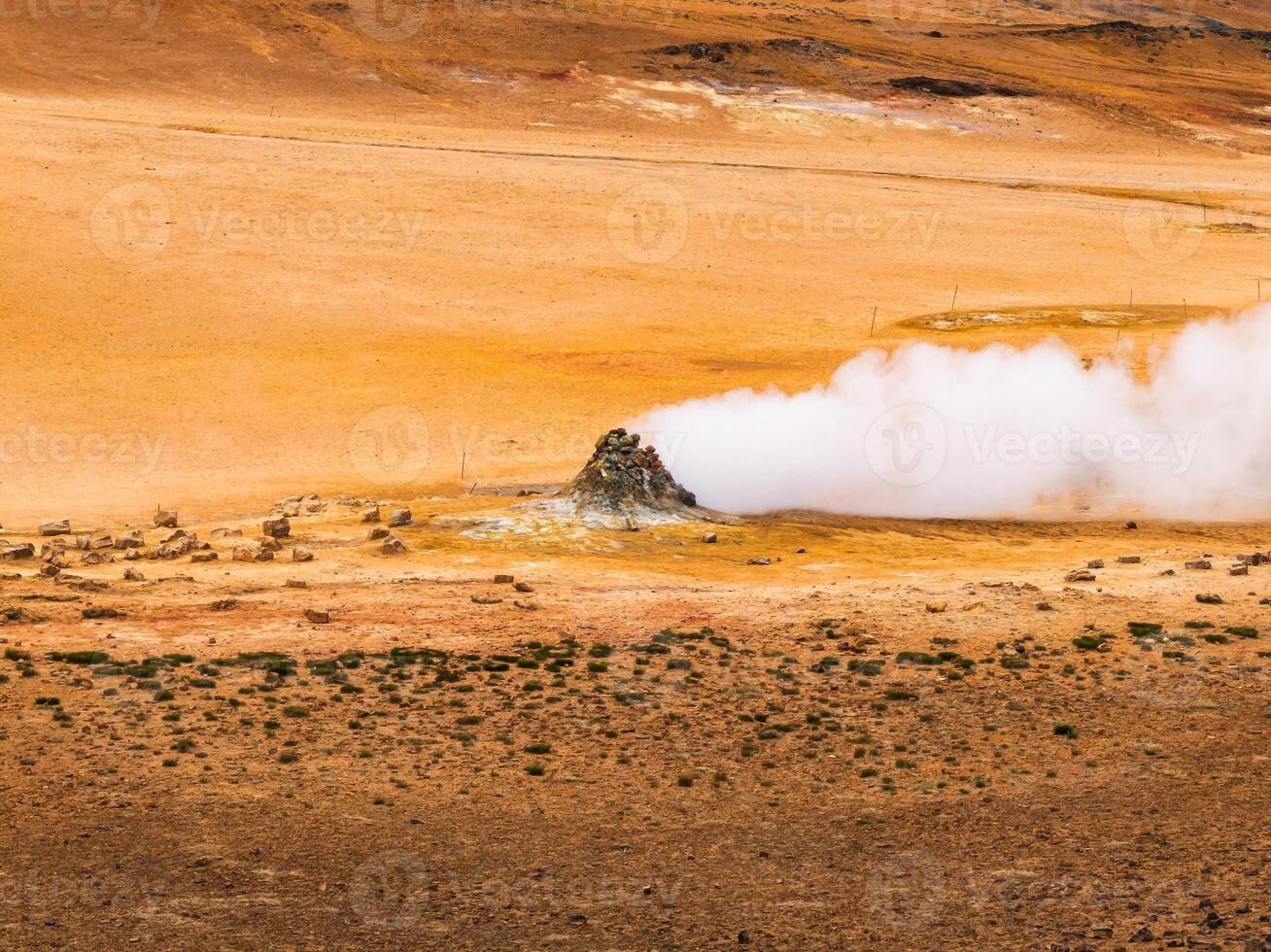 Aerial view of Hverir Geothermal Area in Iceland, capturing boiling mud pools, fumaroles, and the dramatic landscape of this geothermal hotspot near Lake Myvatn. photo