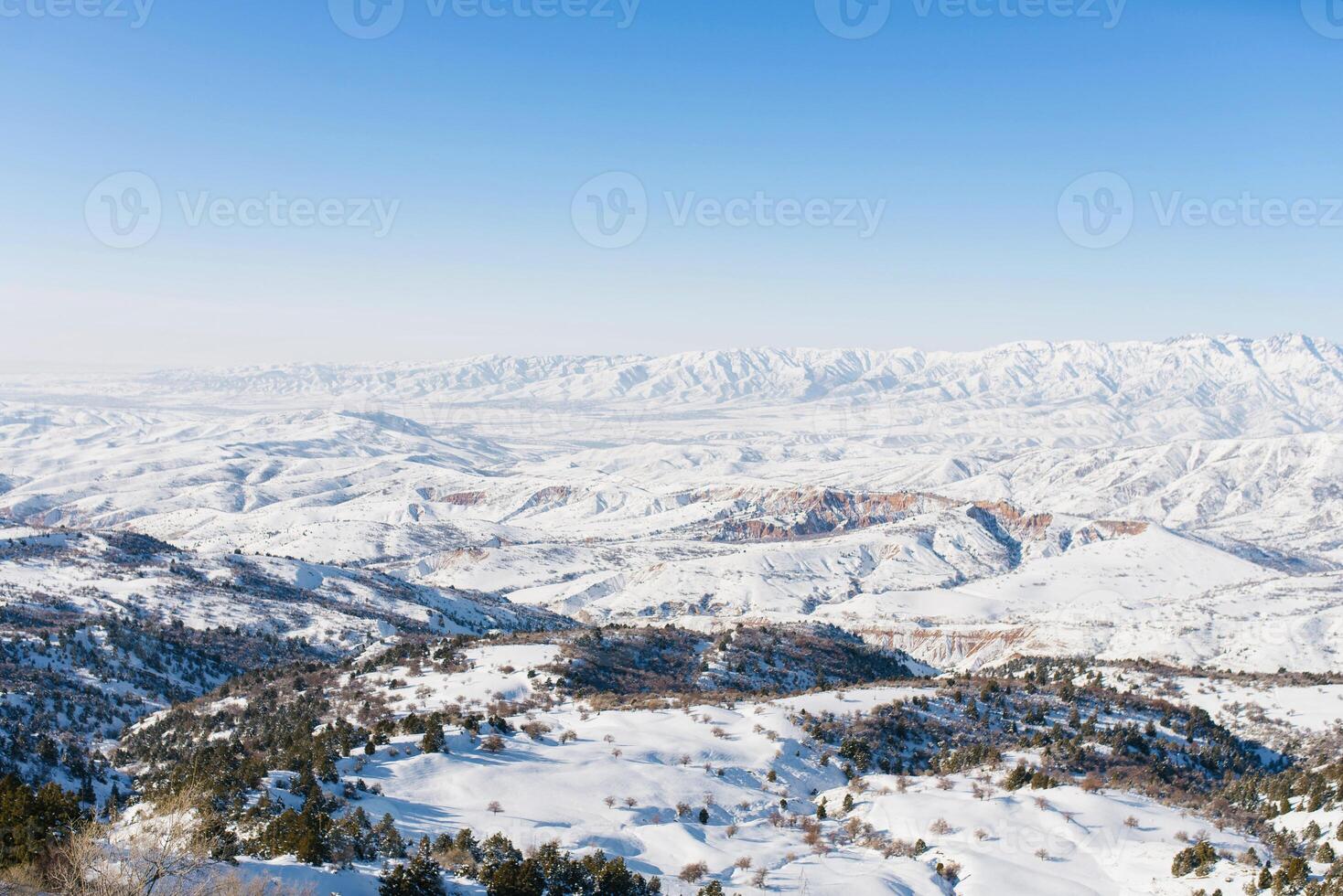 Beautiful winter panorama of the Tien Shan mountains in Uzbekistan in the Beldersay ski resort on a clear winter day photo