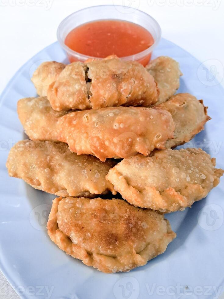 Food called Jalankote, typical of Makassar, South Sulawesi with a white background and delicious chili sauce photo