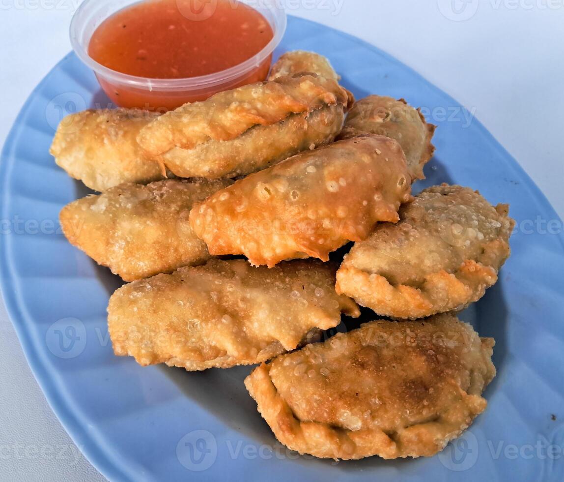 Food called Jalankote, typical of Makassar, South Sulawesi with a white background and delicious chili sauce photo