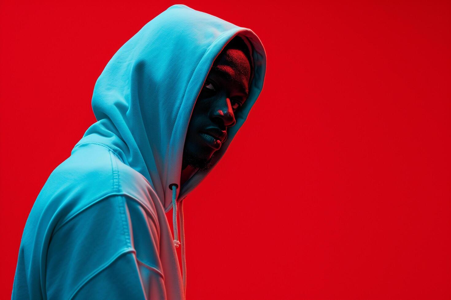 Stylish Male Model in Hoodie with Neon Red Background Contemporary Lifestyle portrait photo