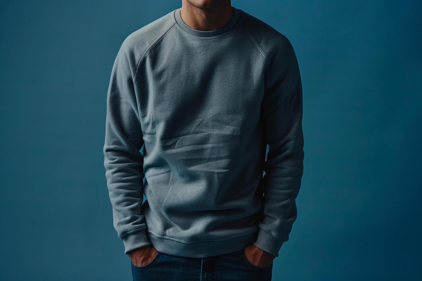 Handsome Fashion Male Model in Stylish Sweatshirt with Deep Blue Lifestyle Background Showcasing Urban Casual Fashion photo