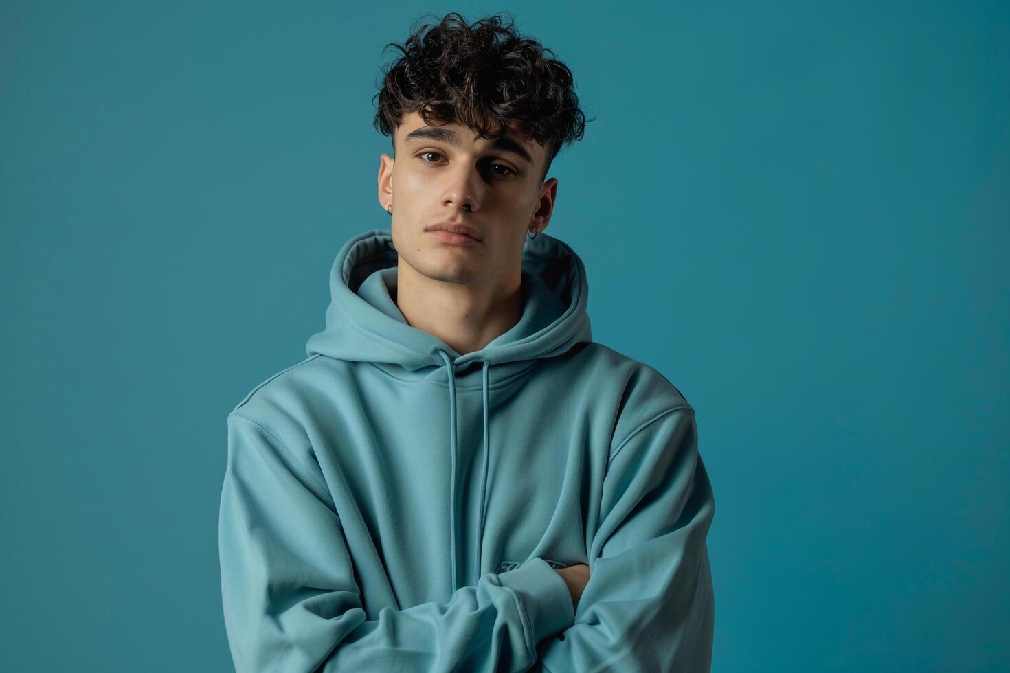 premium Hoodie Clad Male with Ice Blue Background Fashion portrait Highlighting Stylish Lifestyle Choices and Trendy Looks photo
