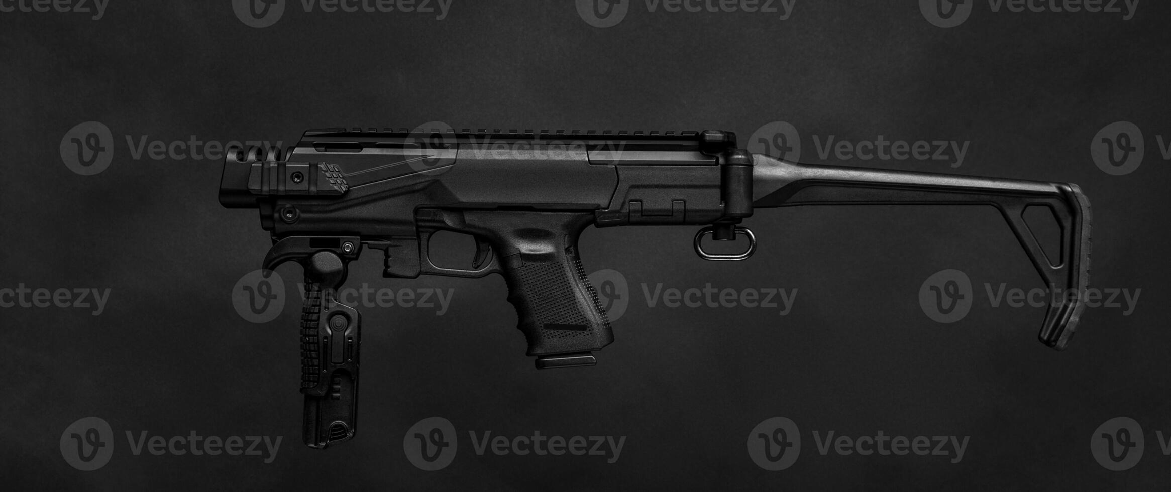 modern black submachine gun on a black photo