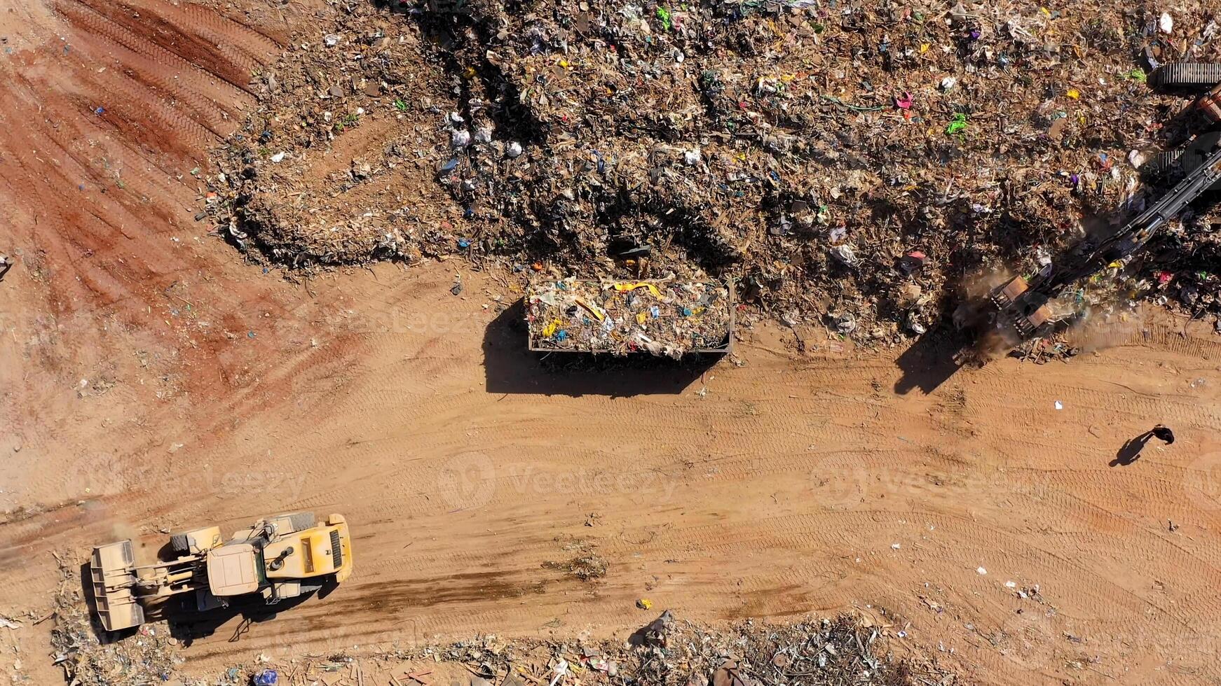 Aerial view of municipal landfill site. Typical waste treatment technology. Large garbage dump and polluted environment from above. photo