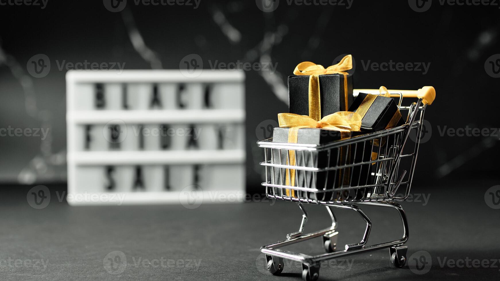 Shopping cart with a yellow credit card inside black friday sale photo
