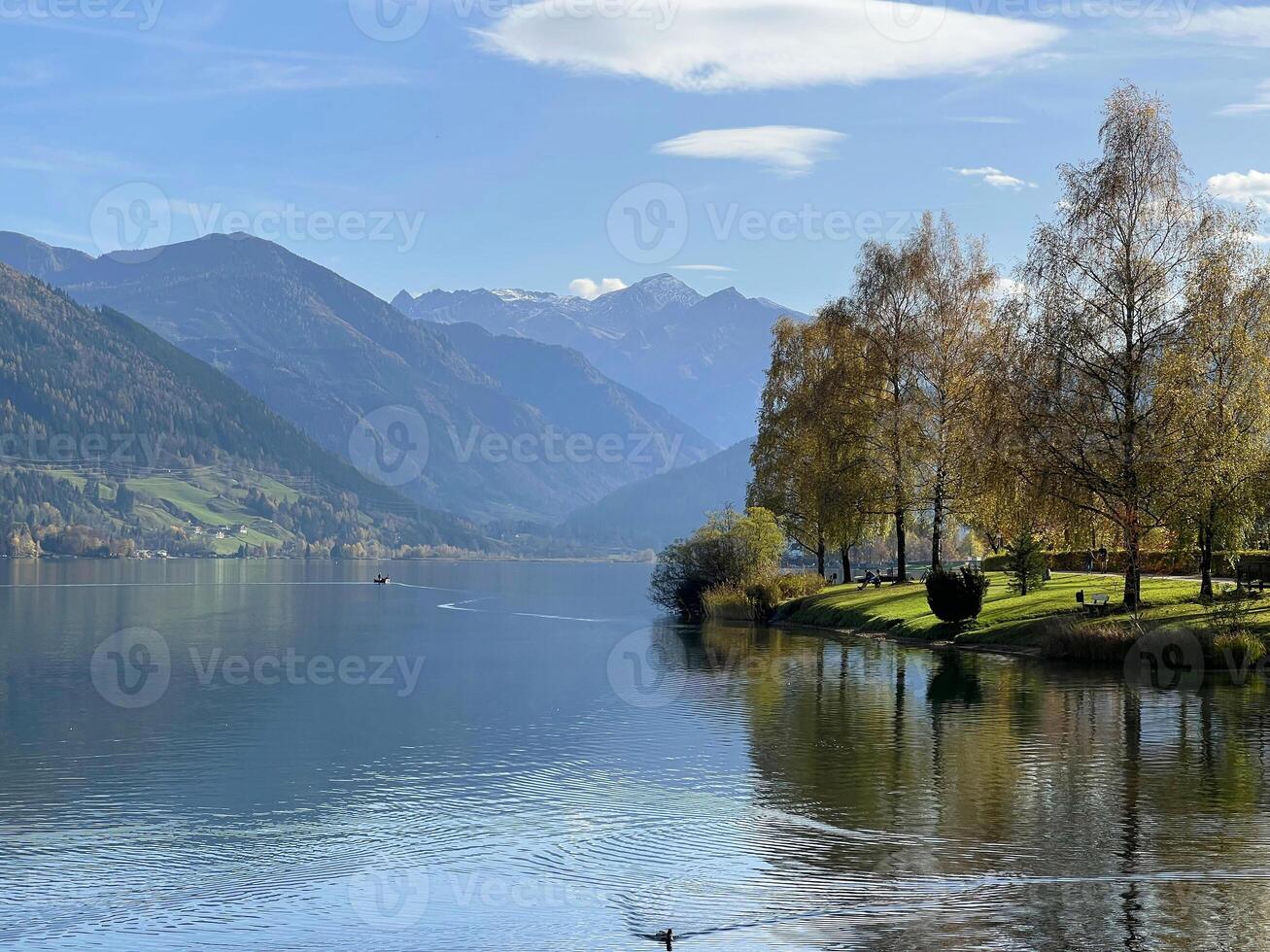 Beautiful view of Zell am See lake in Austria. Green landscape at the background Alps mountains photo