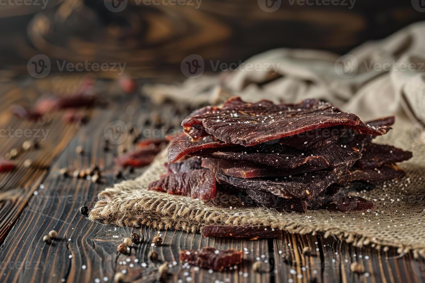 Beef Jerky Displayed on a Tablecloth with Wooden Backdrop photo