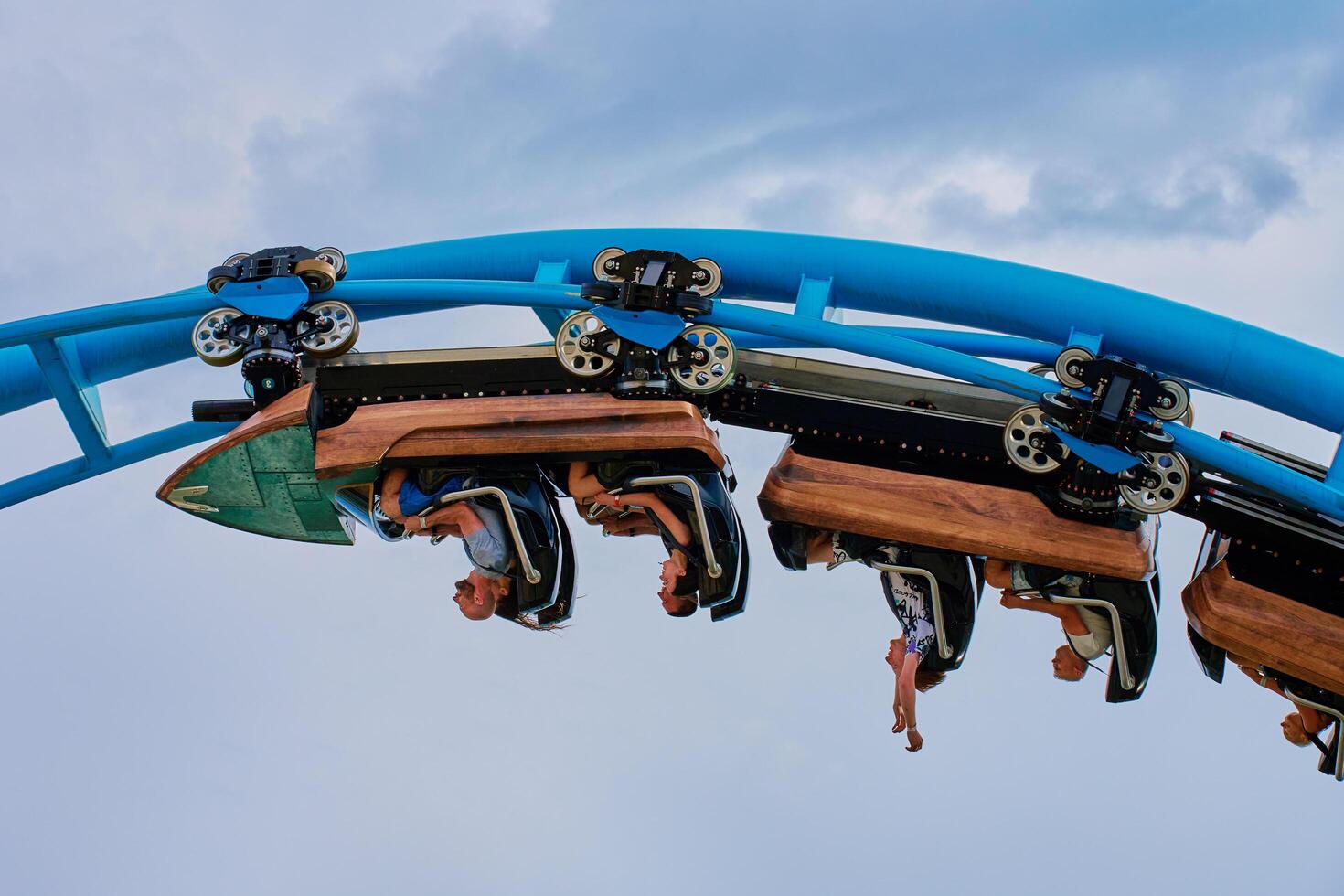 Theme park Energylandia in Zator, Poland. People riding at roller coaster attraction in amusement park. Entertainment at summer holiday. Zator, Poland - May 31, 2024 photo