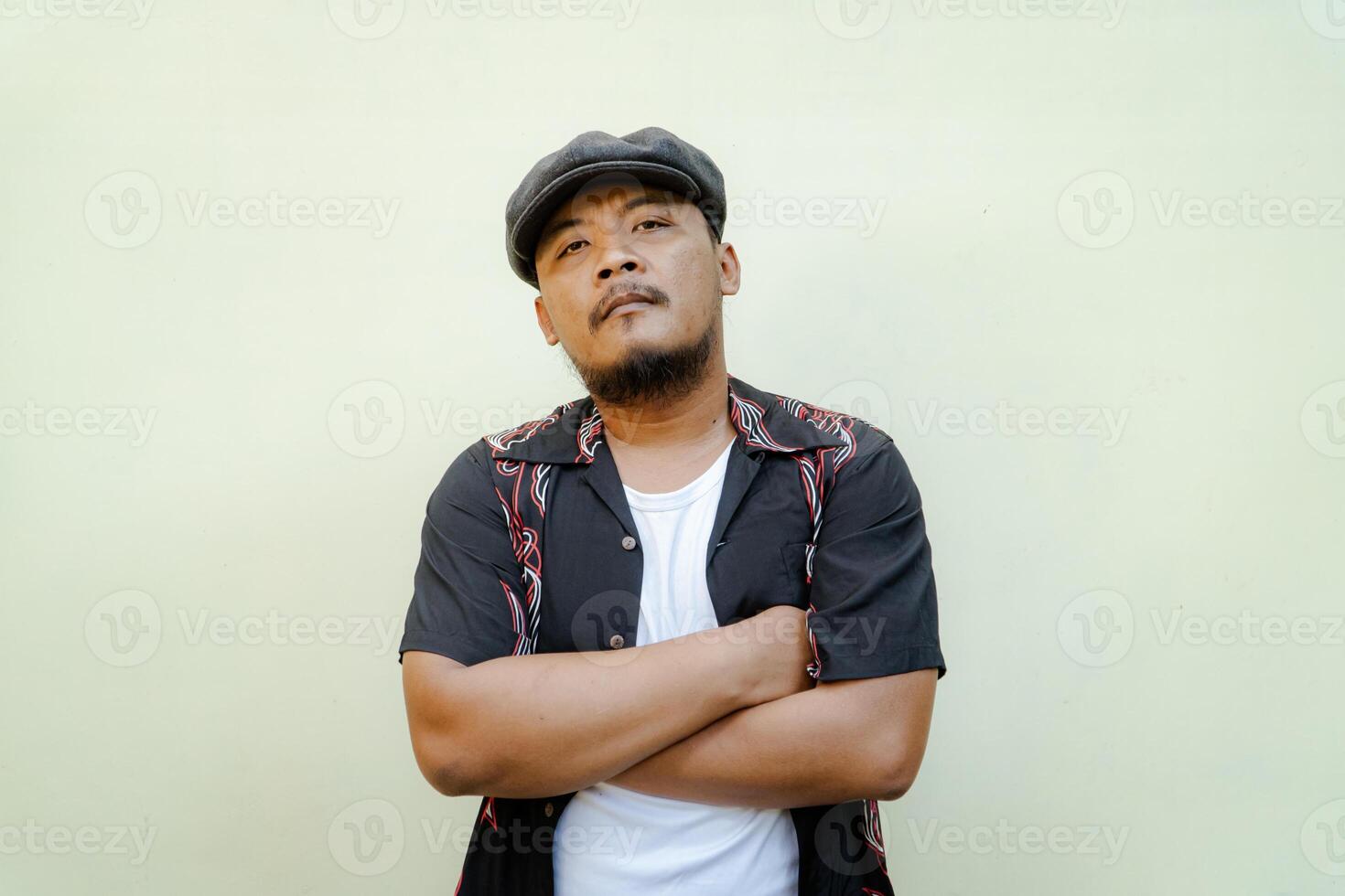 Half-length portrait of adult Southeast Asian man doing various poses and vintage style with hawaiian shirt, white tank top and newsboys cap on beige background photo