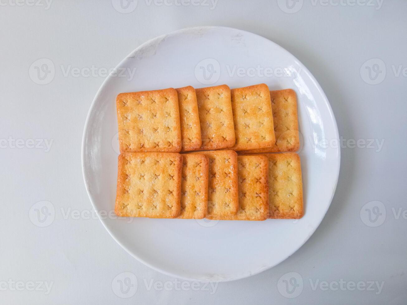 Sugar coated biscuits, also known as malkist, sweet and crispy. Served on white plate photo