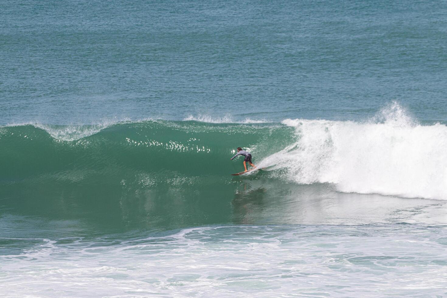 Surfer in a wave about to close in VVF, Anse l'etang, tartane, Martinique, West Indies, France photo