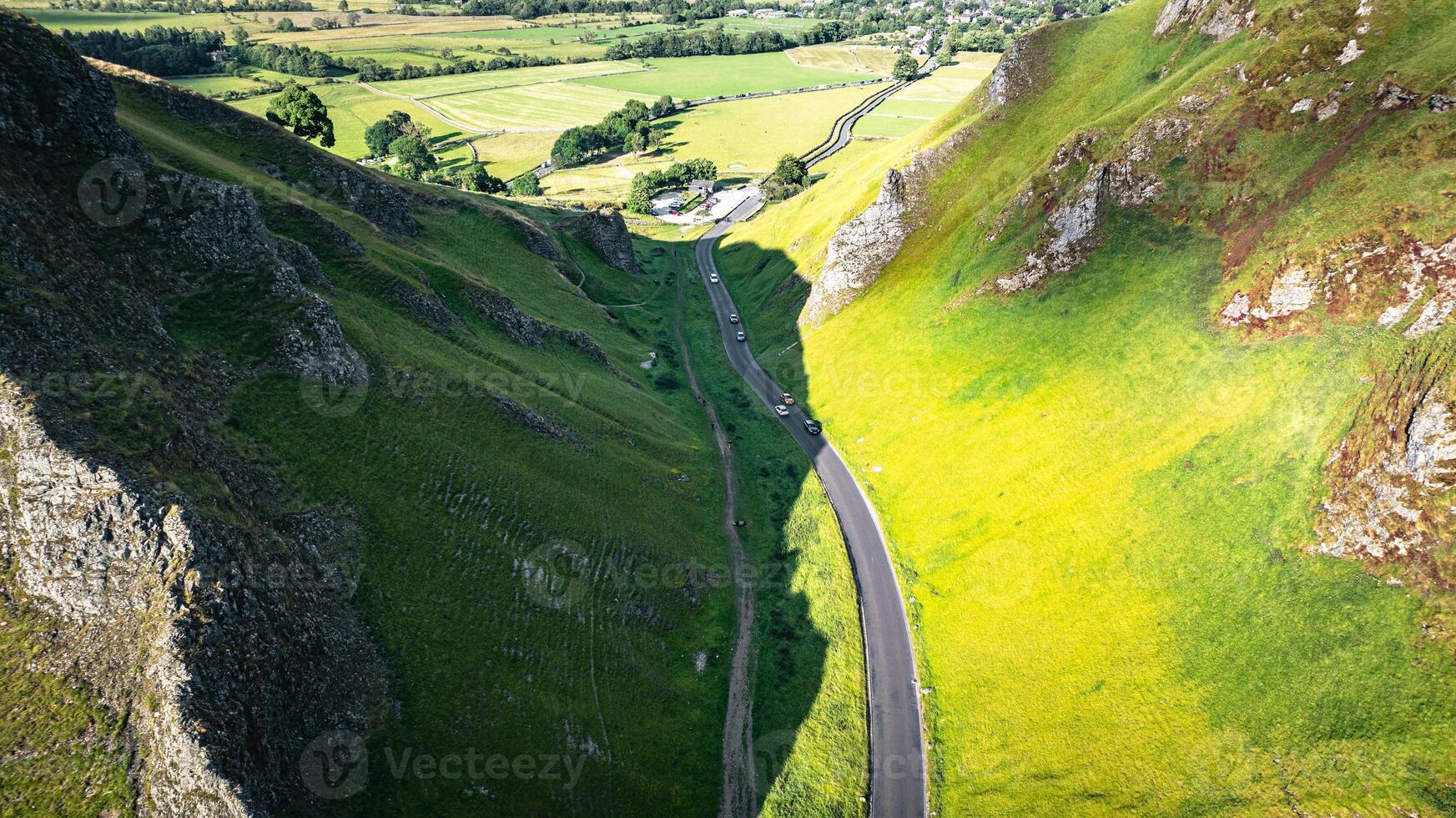 Curvy road between two hills in Yorkshire, Winnats Pass, UK photo