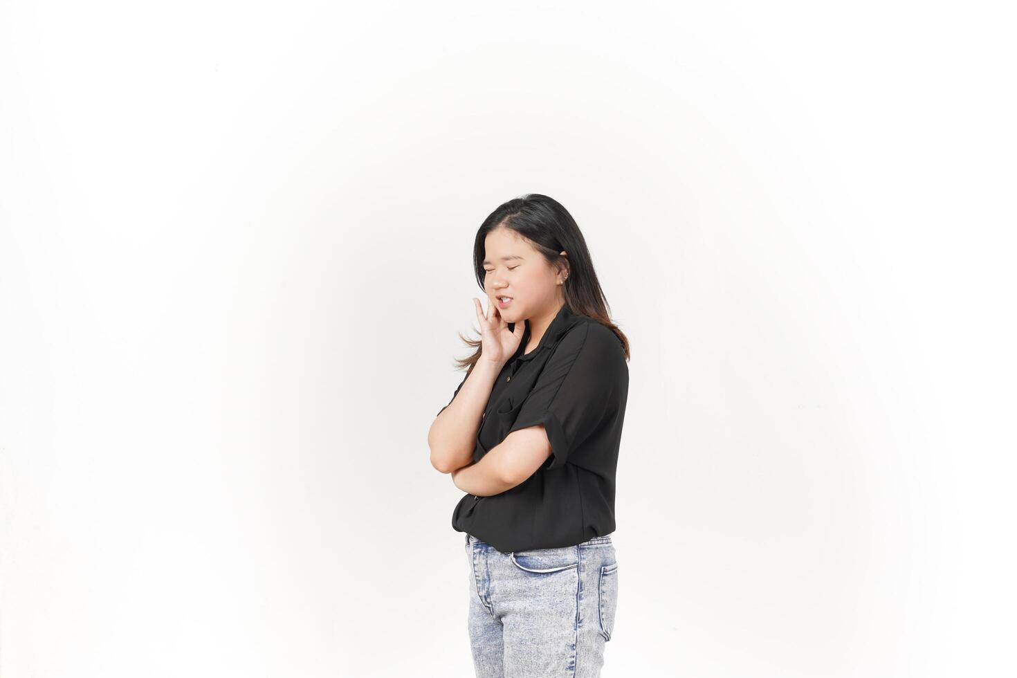 beautiful Asian woman poses with a pained expression, holding her cheek in discomfort due to a toothache against a white background photo