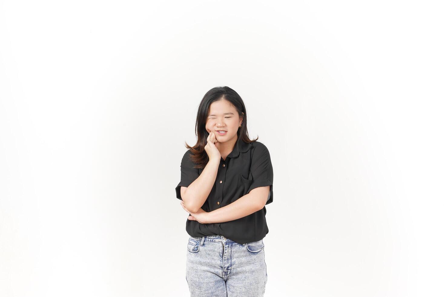 beautiful Asian woman poses with a pained expression, holding her cheek in discomfort due to a toothache against a white background photo