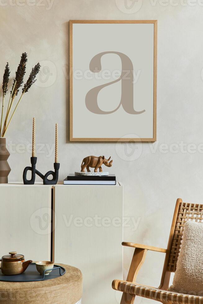 Stylish composition of modern living room with mock up poster frame, wooden sideboard, rattan armchair and boho inspired accessories. Template. photo