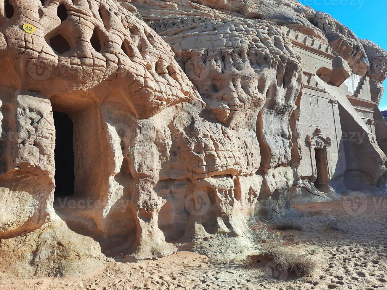 A beautiful view of the caves built into the mountains at the archaeological site of Hegra in Madain Saleh, AlUla in Saudi Arabia. photo