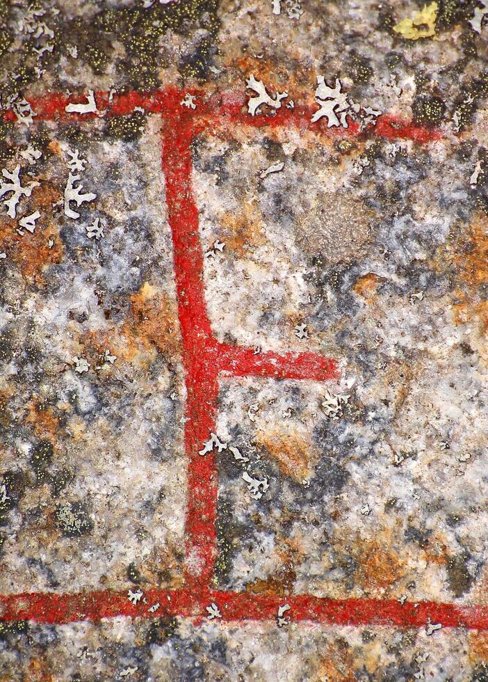 Close up of the Scandinavian rune Naudr from an ancient runestone photo