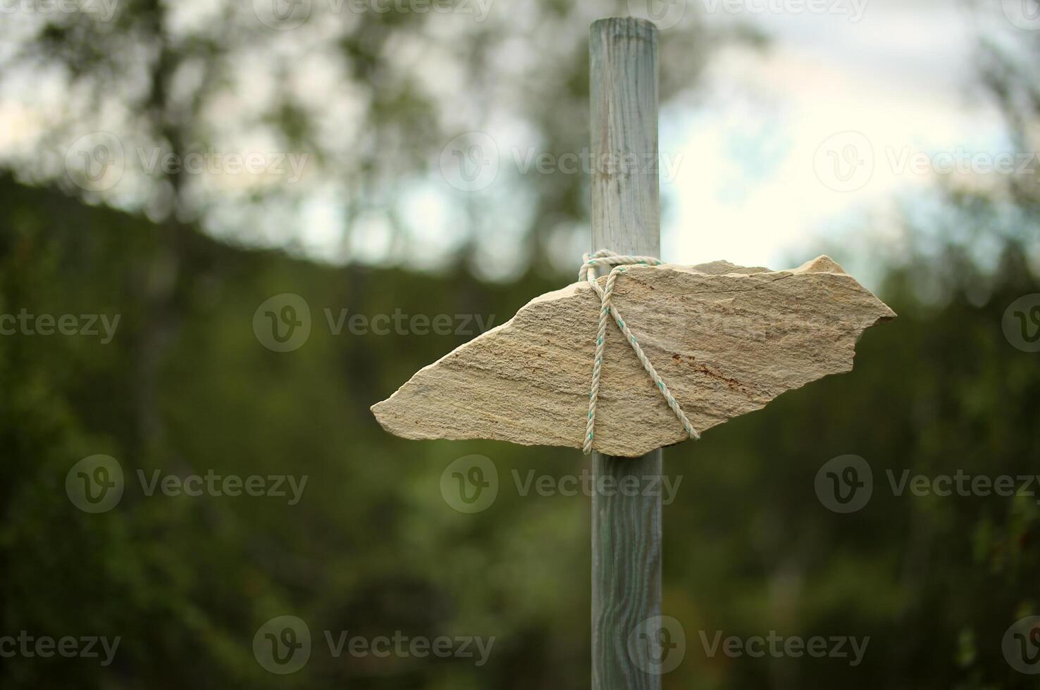 Signpost made of piece of sandstone on a pole photo
