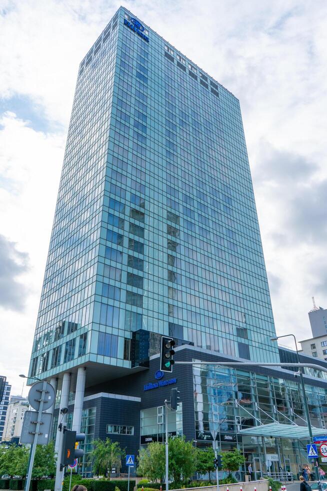 The building and logo of the Polish hotel Hilton Warsaw. Office building skyscraper in the city center. Warsaw, Poland - July 26, 2023. photo