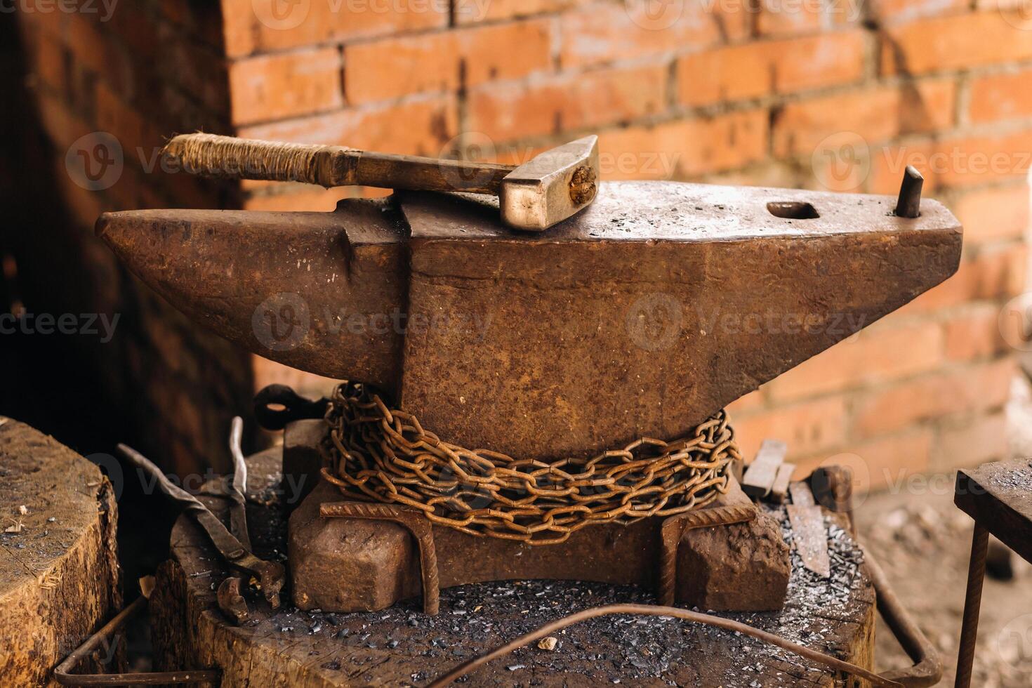Forge, hammer on an anvil standing on the street photo