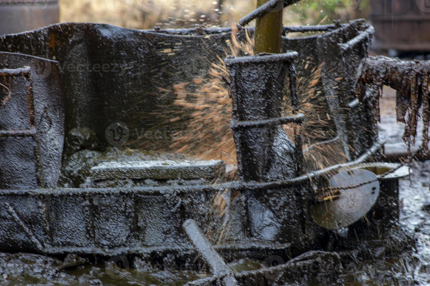 A splash of crude oil that has been taken from an old oil mining well in Wonocolo, Bojonegoro, East Java, Indonesia. photo