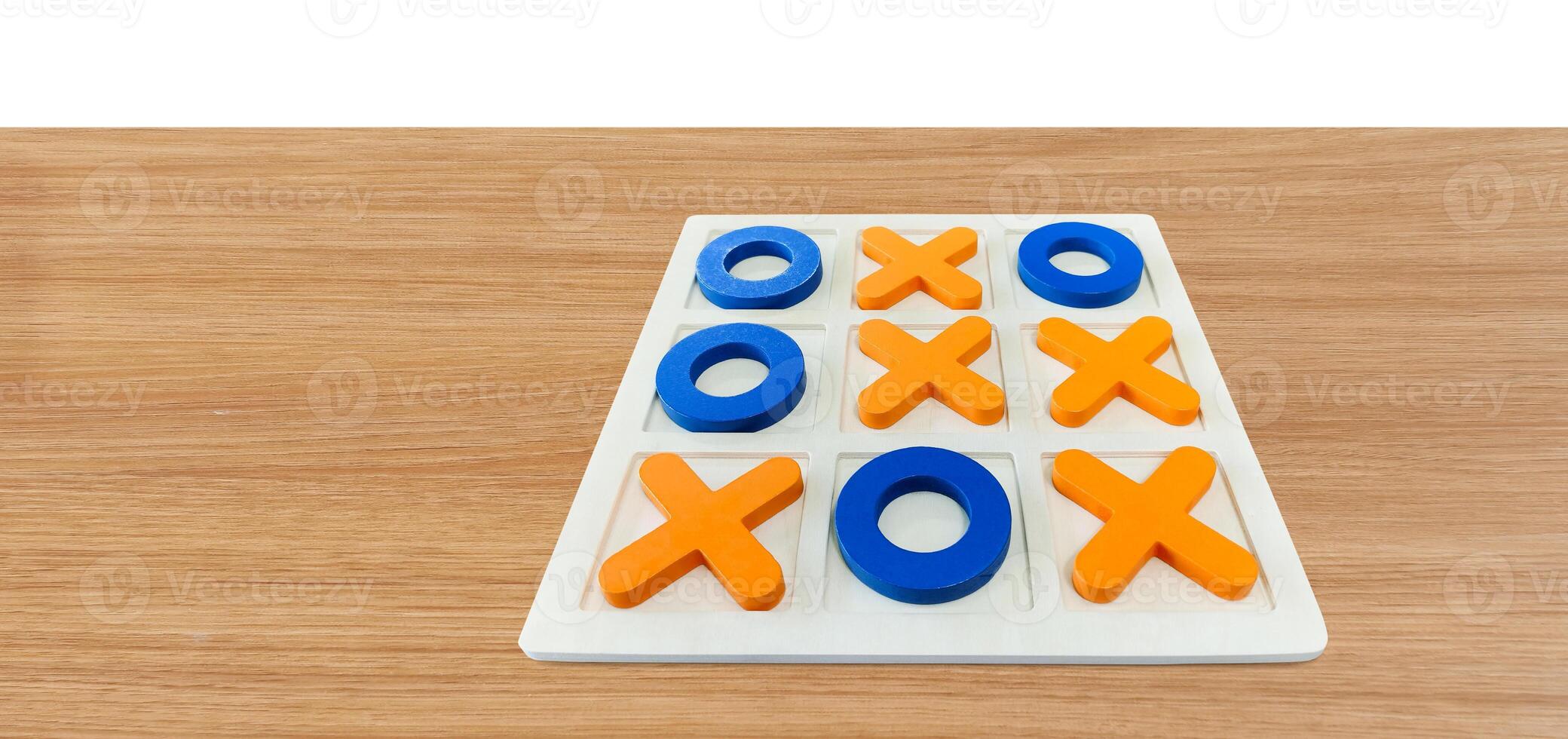 A game of Tic-Tac-To on a wooden table for fun entertainment. photo