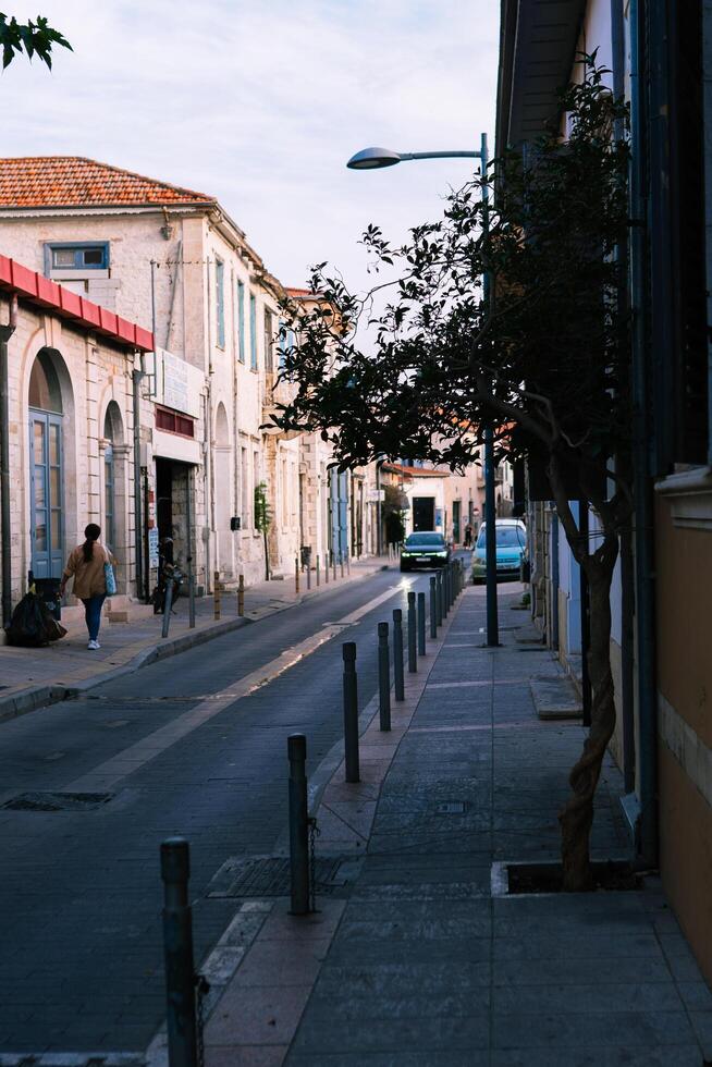 A quiet and hidden lane in the historic part of the Cypriot town of Nicosia,and unrecognizable woman with her back,Nicosia,Cyprus November 4,2023 photo