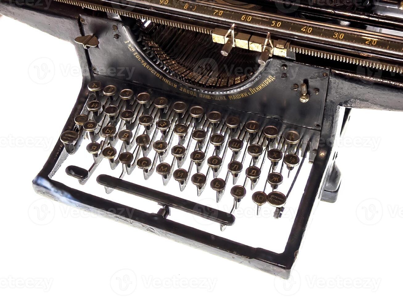 A detailed view of a Soviet-era Leningrad typewriter with Cyrillic keys and elegant retro design. A historical artifact showcasing craftsmanship and utility from mid-20th-century Russia photo