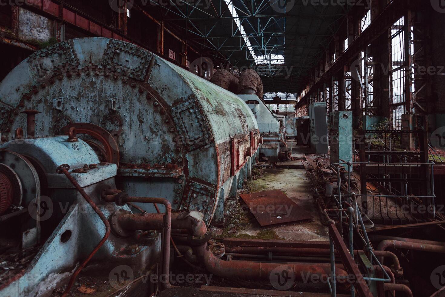 Abandoned destroyed by war and overgrown by plants and moss machinery of Tkvarcheli Tquarchal power plant, Abkhazia photo