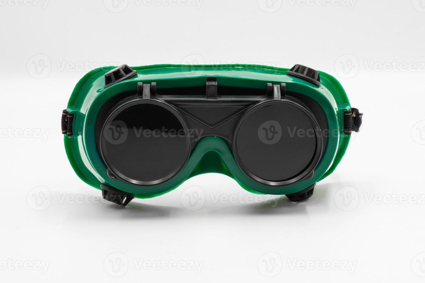Close-up front view of welding goggle designed for protection during welding, featuring a green frame and heavy duty lenses photo