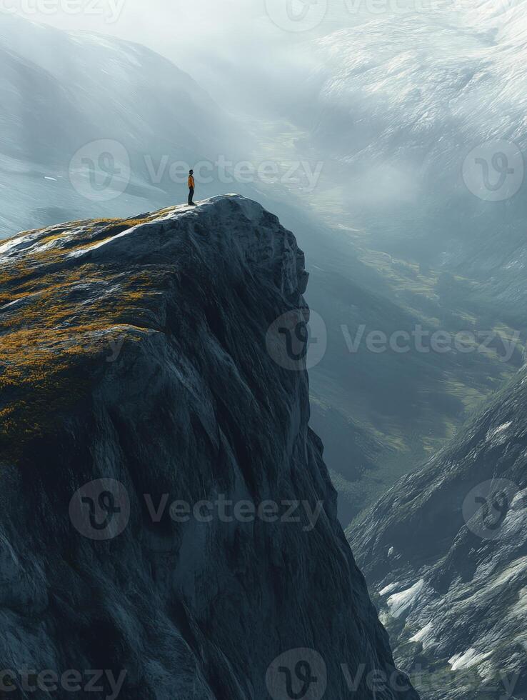 A person standing on a mountain top looking down at the valley below photo