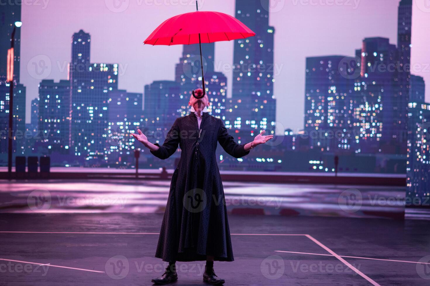 Mysterious Clown Performer with Red Umbrella in Urban Nightscape. photo