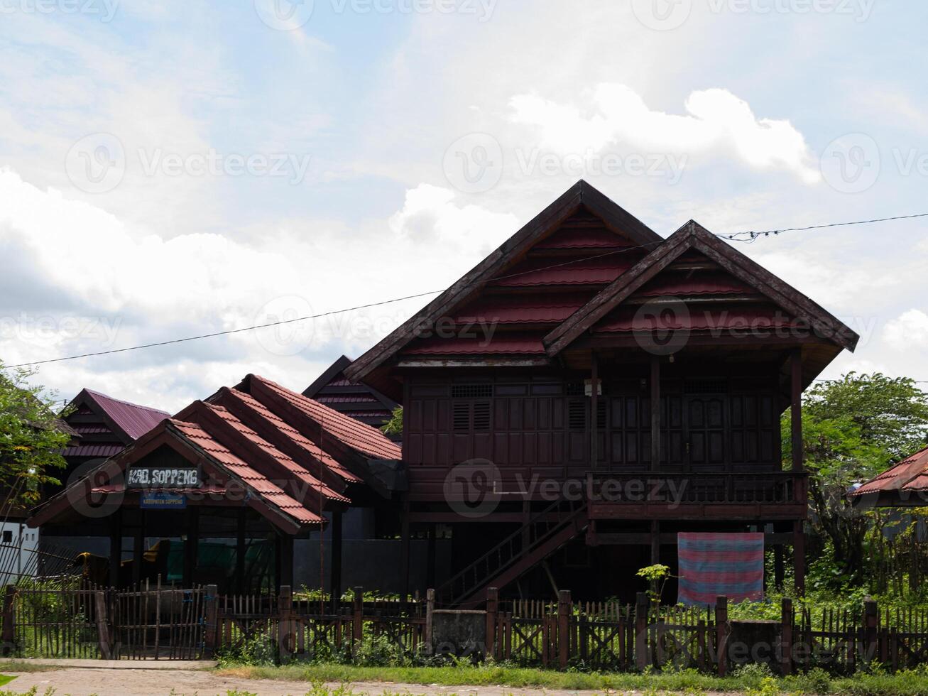 A wide shot of Traditional ethnic house from Soppeng regency South Sulawesi Indonesia with red tile roof photo