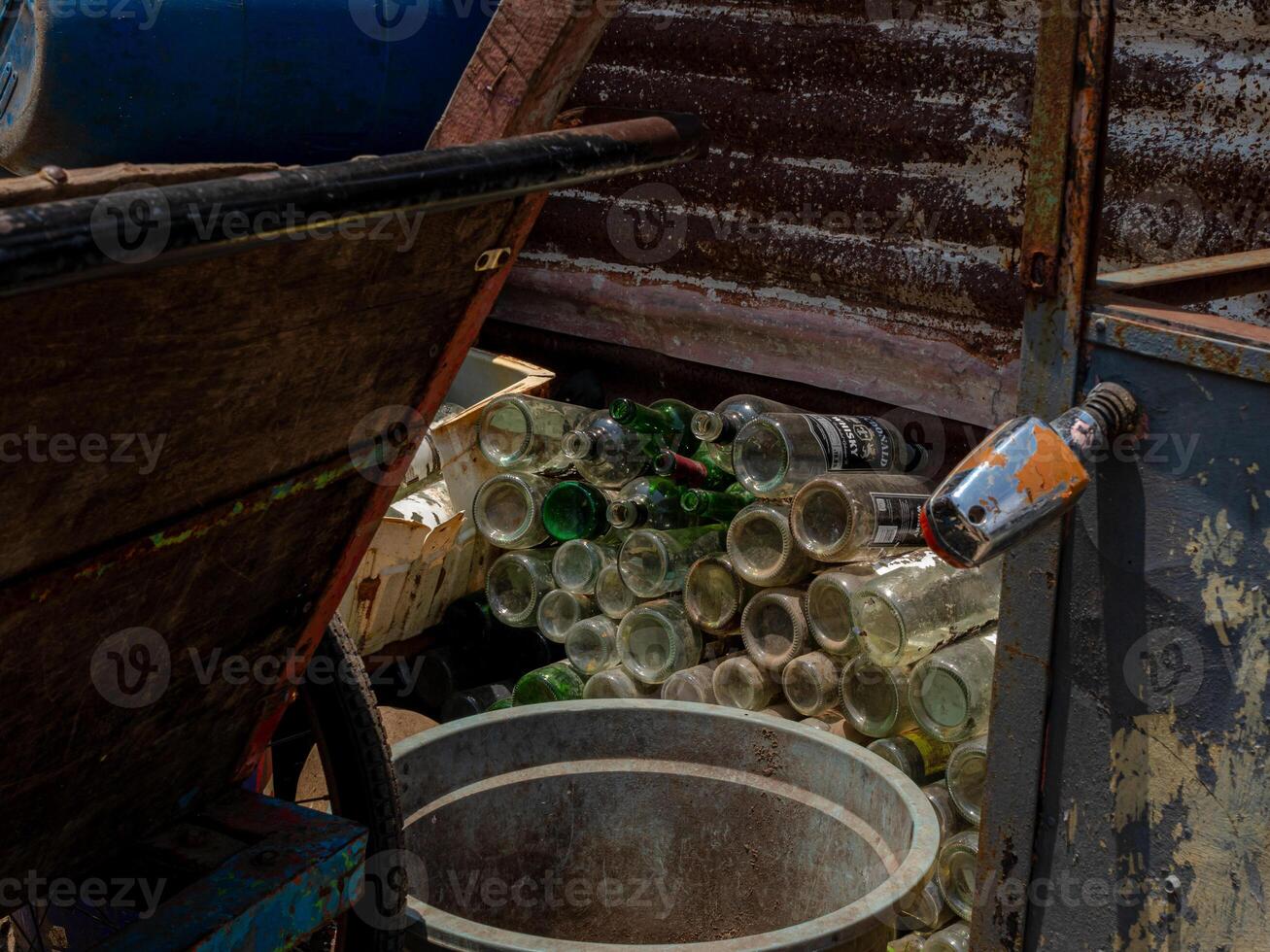 A pile of empty glass bottle discarded as trash to be recycled photo