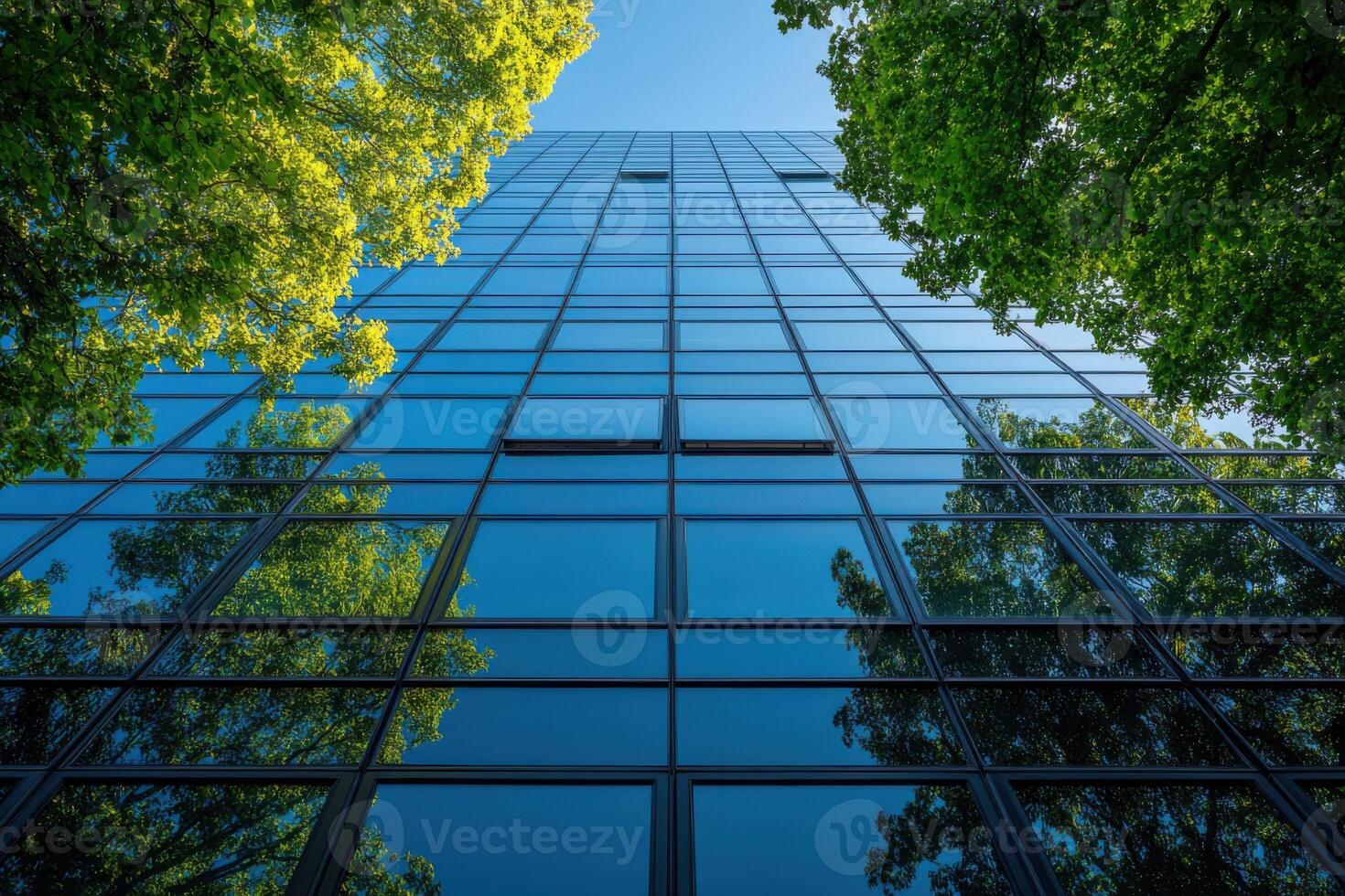 A modern office building with green trees and blue sky, a sustainable business concept photo