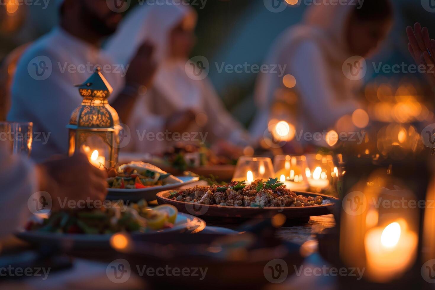 A group of people sitting at a dinner table with candles photo