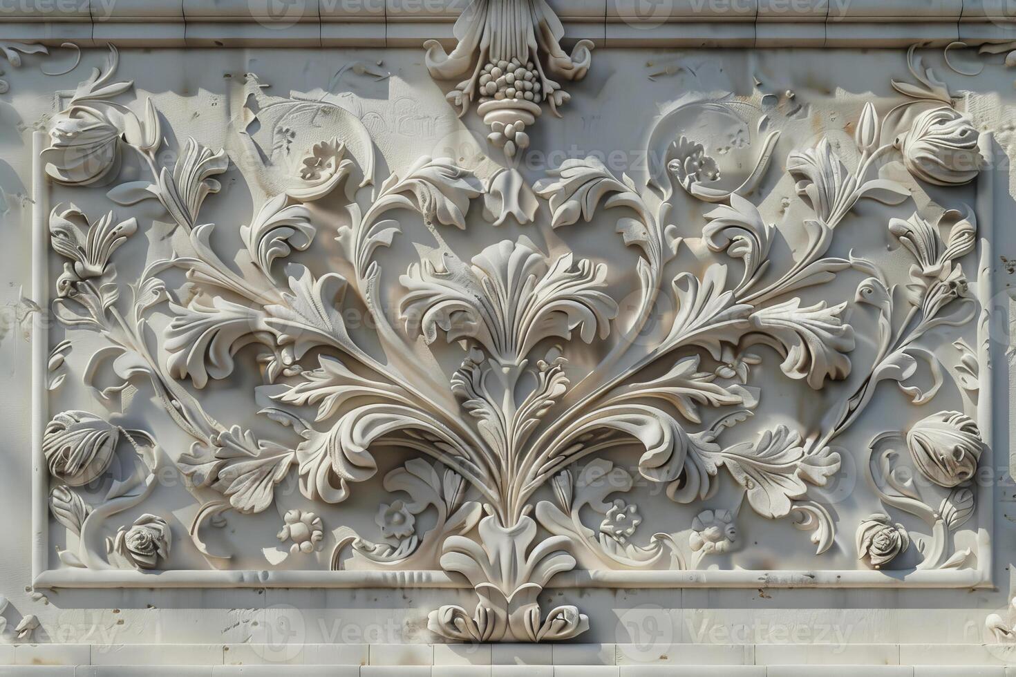 An ornate white marble panel with flowers and leaves photo