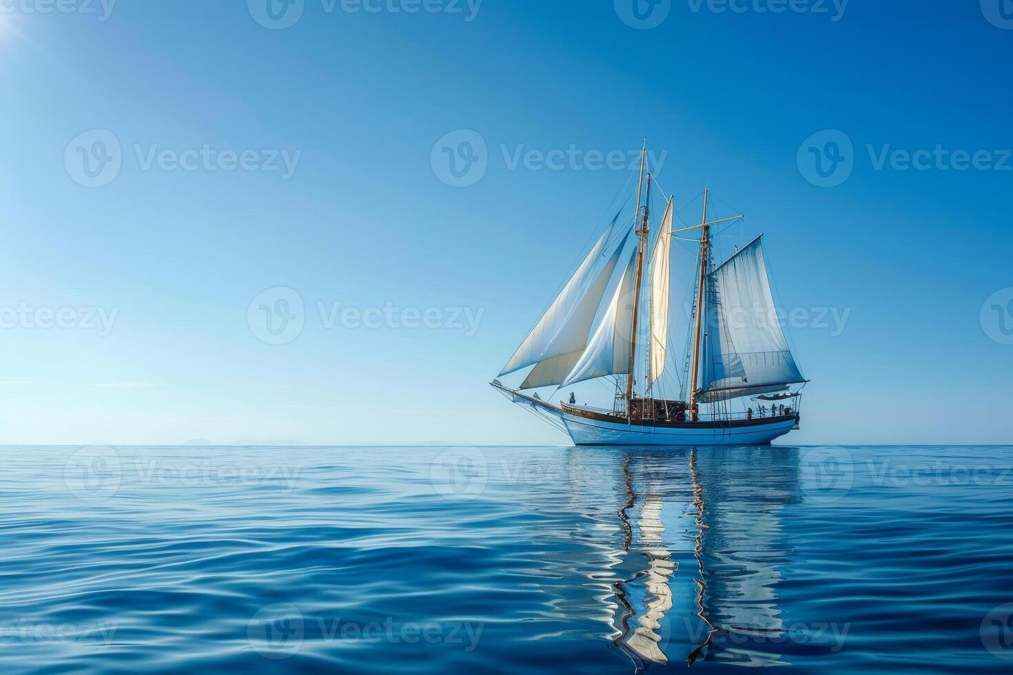 A large sailboat is sailing in the ocean on a sunny day photo
