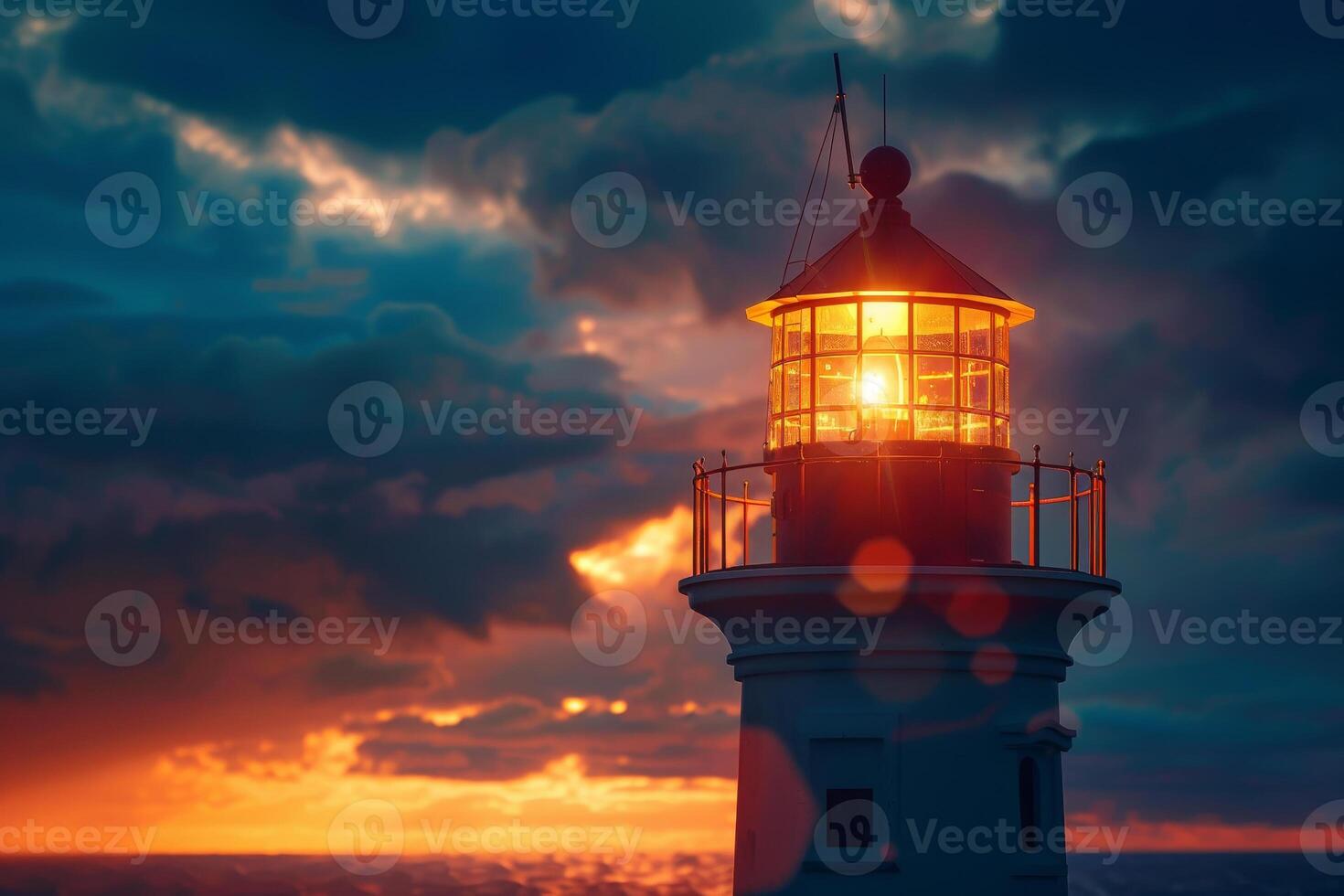 A lighthouse is lit up at sunset photo