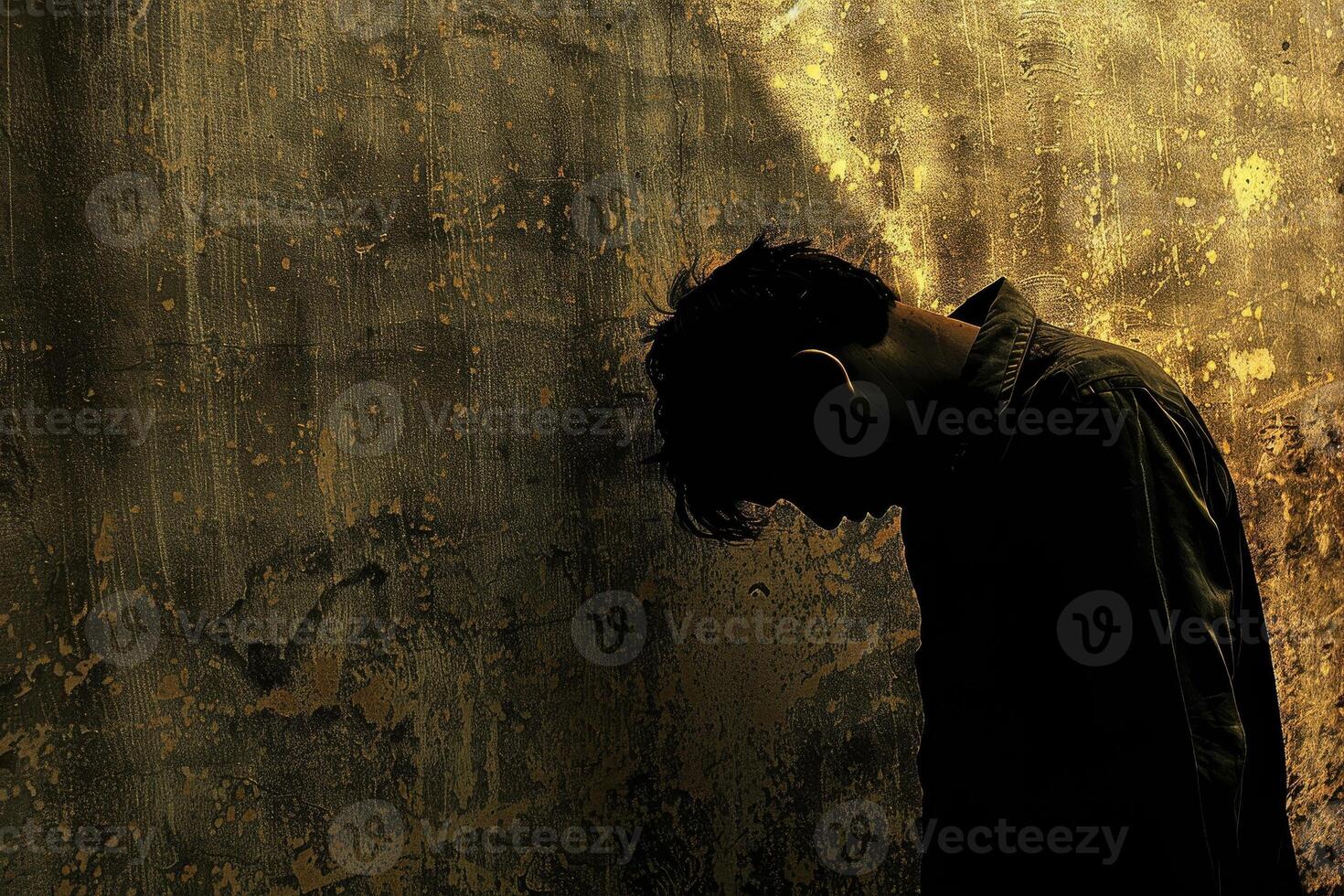 A man leaning against a wall photo